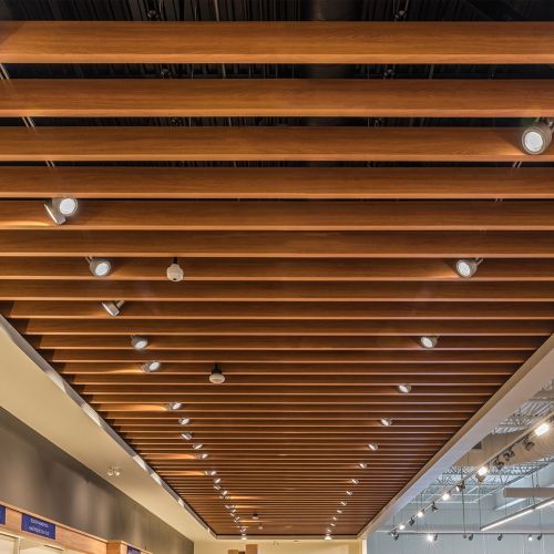 Wood finish baffle ceiling with lighting installed